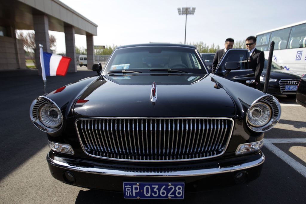 A car with the French national flag is seen ahead of French President Francois Hollande and his companion Valerie Trierweiler's arrival in Beijing